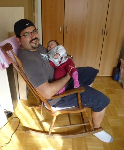 Oscar holding Olivia in the rocking chair